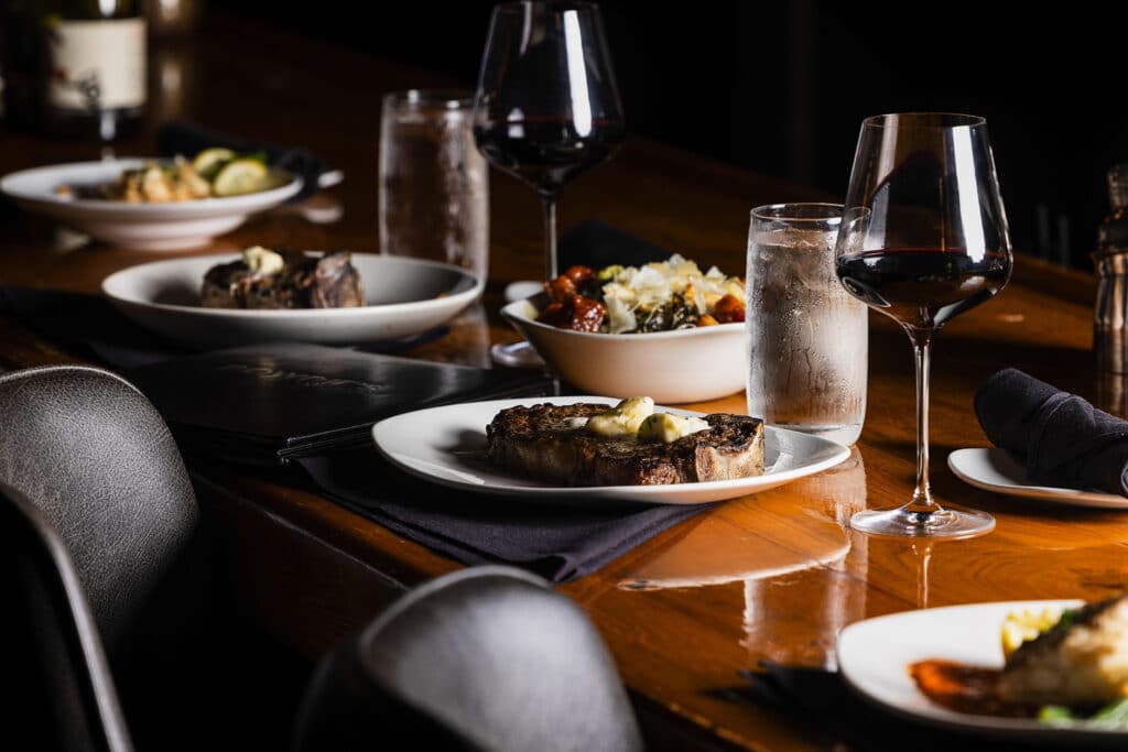 The bar at Bowdie's Chophouse is set with steaks and red wine for Valentine's Day.